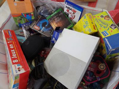 a basket full of toys and games on the floor