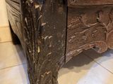 a close up view of a wooden bed with carvings on it