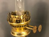 a small light that is on top of a gold lamp