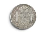 an old silver coin with a crown on top of it