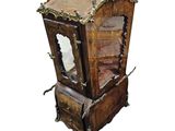 a small wooden clock with a mirror on top of it