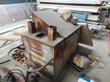 a rusted metal furnace sitting on the floor