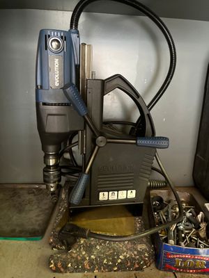 a picture of a drill and other tools sitting on a table