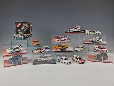 many different models of cars in display cases on a table