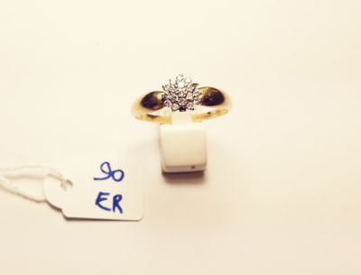 a gold ring with a diamond on it and a price tag
