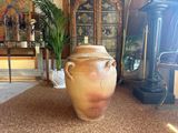 a large vase sitting on the floor in a living room