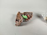 a piece of cake that has a green candy on it