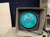 a green traffic light in a cardboard box on a table