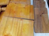 several pieces of wood are stacked on top of a refrigerator