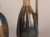 two vases sitting next to each other on a table