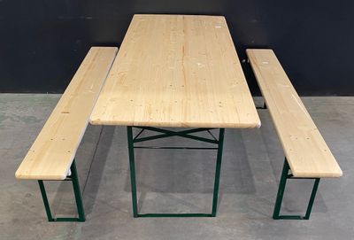 a wooden table and two benches in a room