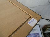 a close up of a piece of wood with a sticker on it