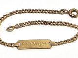 an image of a gold chain bracelet with a nameplate on it