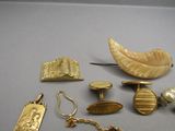 several pieces of jewelry are displayed on a gray surface