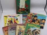 plusieurs livres pour enfants sont alignés sur une surface blanche