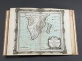an old book with a map of africa on it on a table