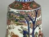 a vase with a design on it sitting on a table