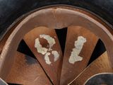 a close up view of a rusted helmet with numbers on it