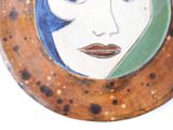 a plate with a picture of a woman ' s face on it