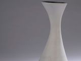 a white vase that is sitting on a table
