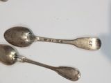 two spoons that are sitting on a table