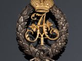a close up of a badge with a crown on it