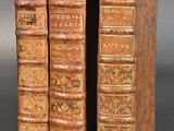 a pair of old books sitting on top of each other
