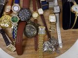 many different types of watches on a wooden plate