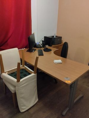 a desk with a chair and a computer on it