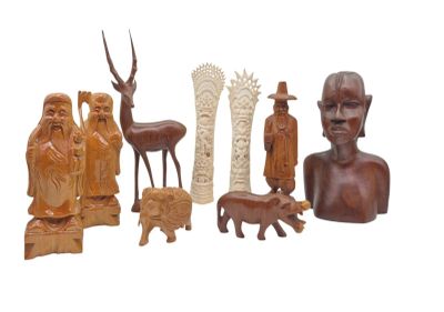 a lot of wooden sculptures that are on a white surface