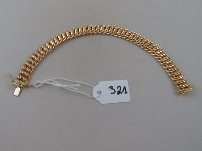 a gold bracelet that has a price tag on it