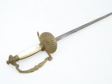 a sword that is laying on a white surface