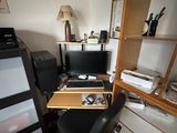 a desk with a computer on top of it in a room