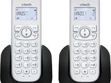 the two phones are sitting side by side next to each other
