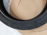 two tires are sitting on top of a cardboard box on a table