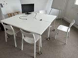 a white table with a computer on top of it