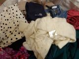 a basket full of clothes and a teddy bear in it