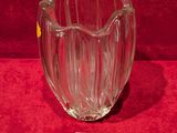 a glass vase that is sitting on a red surface