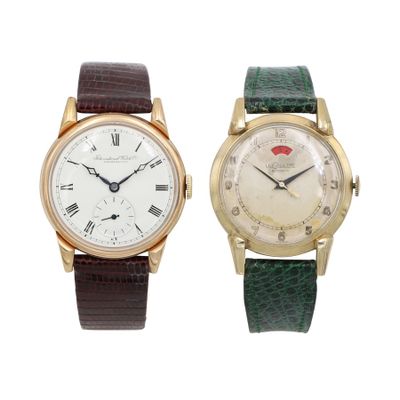 an image of a couple of wrist watches sitting next to each other