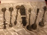 a lot of silver spoons and spoon spoons in a red case