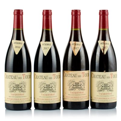 three bottles of red wine are lined up on a white surface