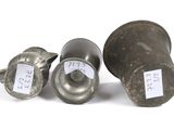 three metal knobs with labels on them sitting next to each other