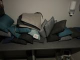a pile of pillows on a table with a price tag on it