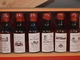 bottles of wine in a wooden box on a red surface