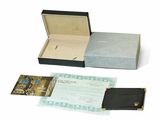 a black box with a note inside of it on a white surface