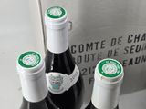 three bottles of wine sitting next to each other on a table