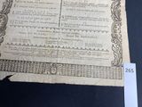 a very old document with writing on it on a table