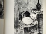 an open book with a drawing of a cat sitting on a chair