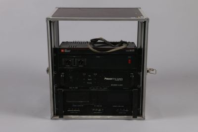 a black radio sitting on top of a metal case