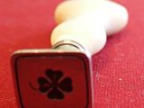 a close up of a rubber stamp with a four leaf clover on it
